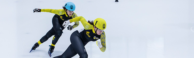 two people speed skating on ice